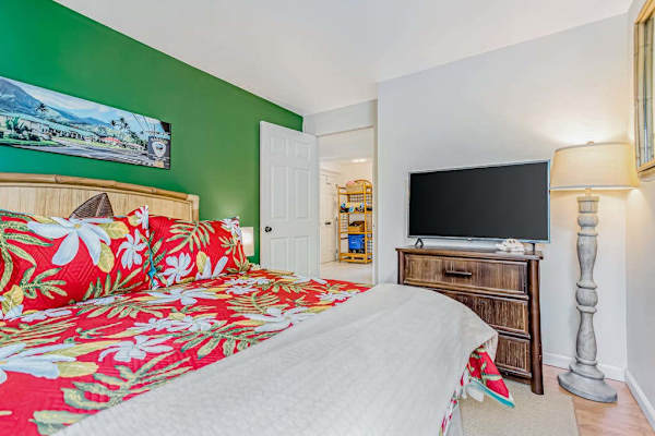 Guest bedroom with queen bed and flat screen tv.