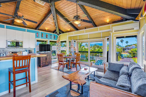 Living room with panoramic views comfortable seating and a flat screen tv.  In this open concept design with the kitchen, living room and dining room, you can always stay engaged with your guests.