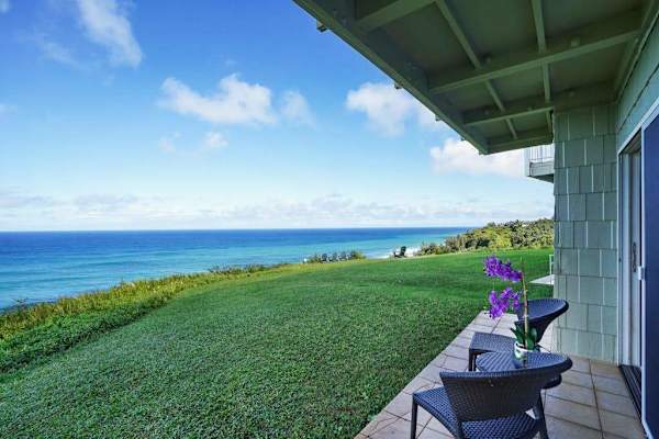 Oceanfront lawn with lounge seating and sweeping coastal views