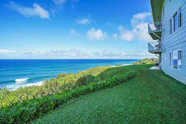 Expansive oceanfront lawn with sweeping views of the coastline