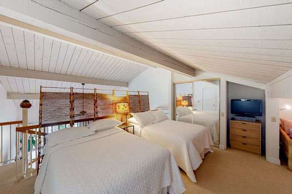Cozy loft featuring two comfortable beds, perfect for restful stays