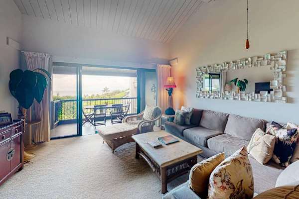 Living room comfortable seating beside ocean facing glass doors
