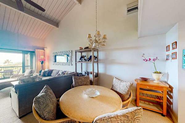 Contemporary lounge provides comfortable seating beneath elegant island artwork today