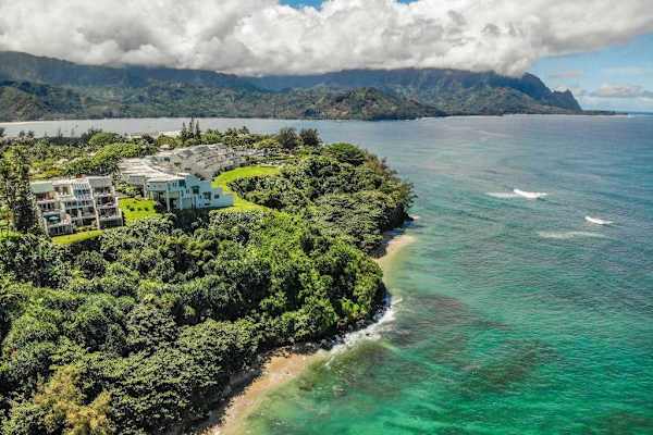Aerial view of the oceanfront resort surrounded by tropical beauty