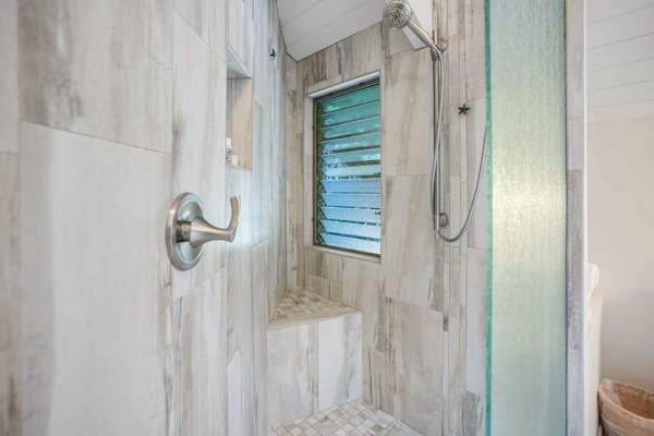 Beautiful walk-in shower with elegant stone tile.