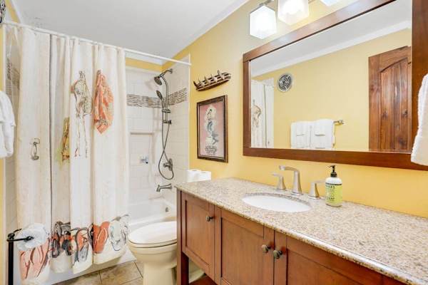 Primary bathroom featuring a clean tub and shower combination.