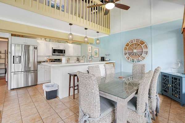 Dining area with seating for six, plus two additional counter stools at the kitchen island.