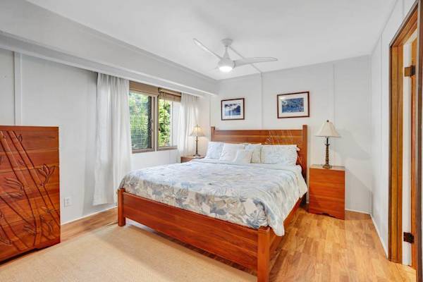 Spacious primary suite featuring a plush king bed and private ensuite bathroom.