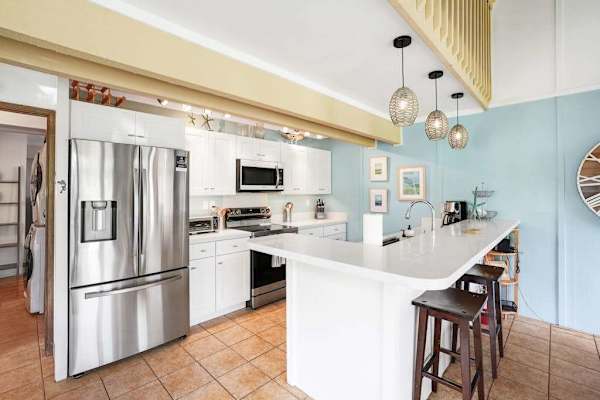 Newly remodeled modern kitchen featuring stainless steel appliances and an island for extra counter space.