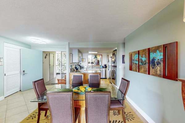 Bright kitchen corridor showcases modern appliances colorful art and openness