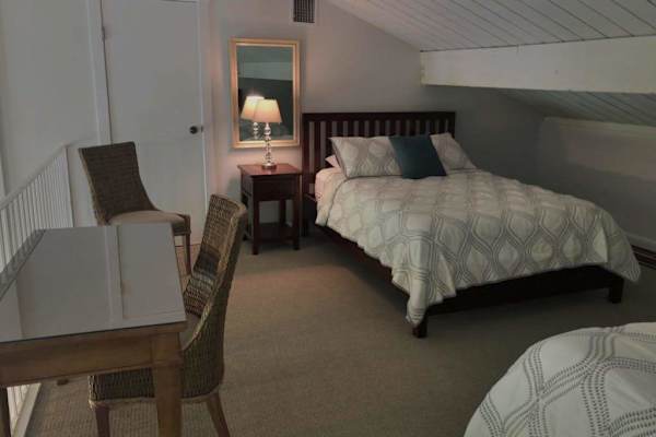 Cozy loft offers bedside table, seating, and restful sleeping space