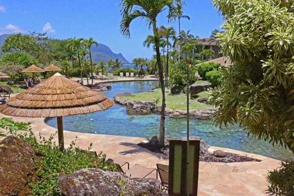Tropical lagoon reflects palms, gardens, and peaceful resort surroundings nearby
