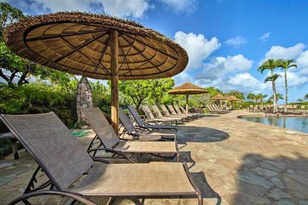 Comfortable seating by the pool with scenic views and blue skies