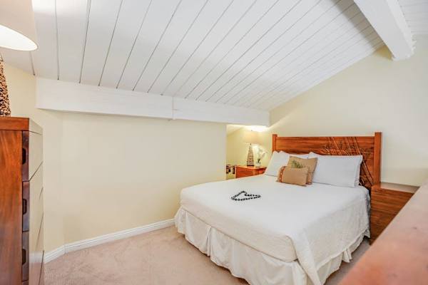 Cozy bedroom features soft bedding, ceiling fan, and peaceful surroundings