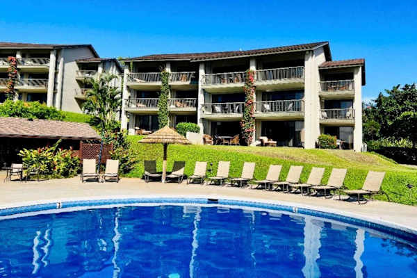 Resort pool offers swimming with tropical gardens and mountain surroundings