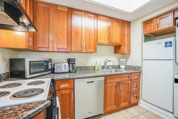 Bright kitchen offers generous storage, essential appliances, and convenient workspace