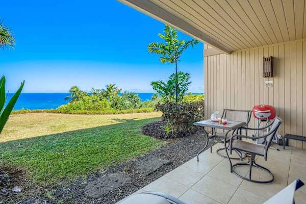 Shaded patio creates a comfortable retreat beside gardens and lawns