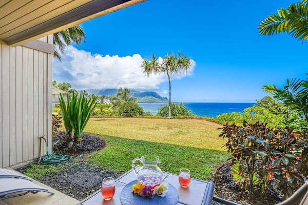 Open terrace blends practical furnishings with lush tropical landscaping nearby