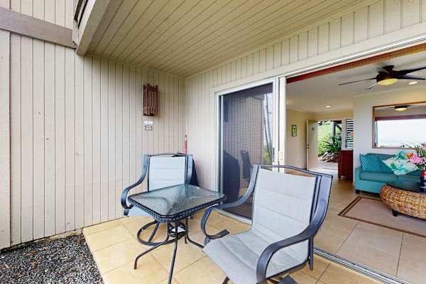 Patio seating offers a charming spot beside landscaped lawns