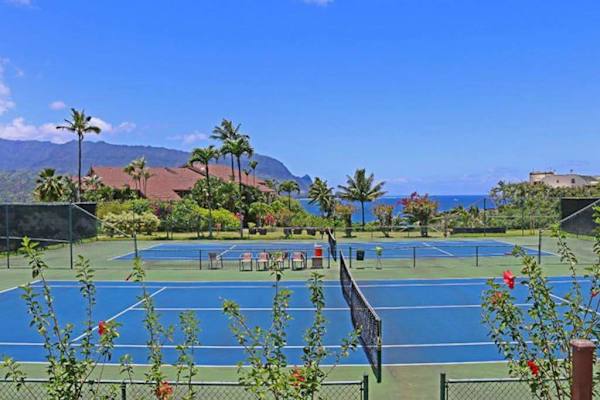Enjoy a friendly tennis match beneath beautiful sunny island skies