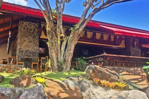 Welcoming resort entrance showcases warm island charm and natural surroundings