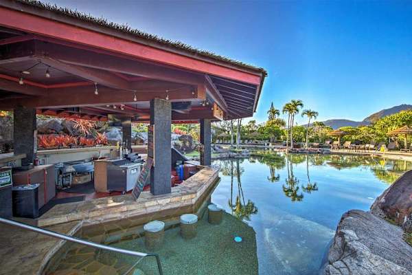 Enjoy relaxing poolside moments from this shaded tropical gathering area