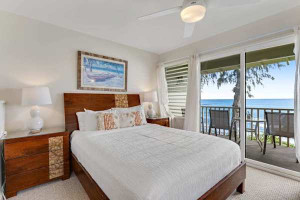 Bright bedroom with direct access to the private oceanfront lanai.