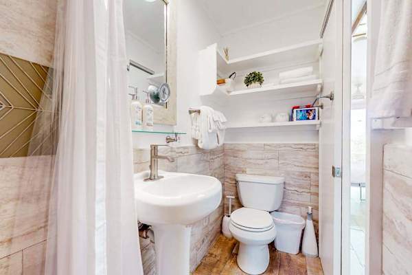 Compact full bathroom with a walk-in shower and essential amenities.