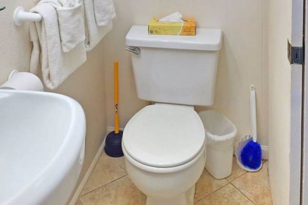 Clean full bathroom stocked with essential amenities.