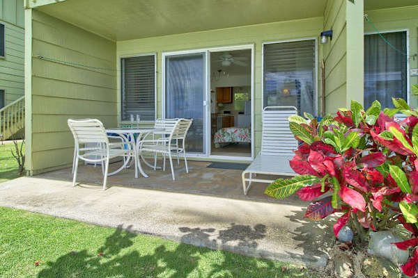 Private lanai with outdoor seating overlooking beautifully landscaped grounds.