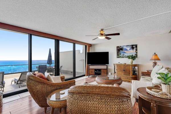 Inviting living room with floor-to-ceiling windows that bring the beauty of the ocean indoors