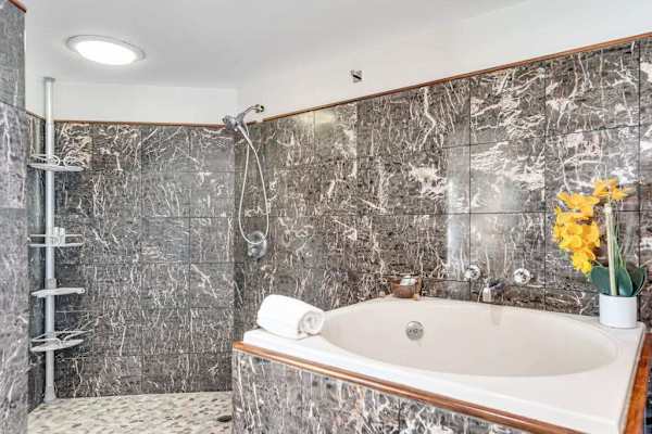 Primary en-suite with jetted tub and rain shower, ideal for total relaxation