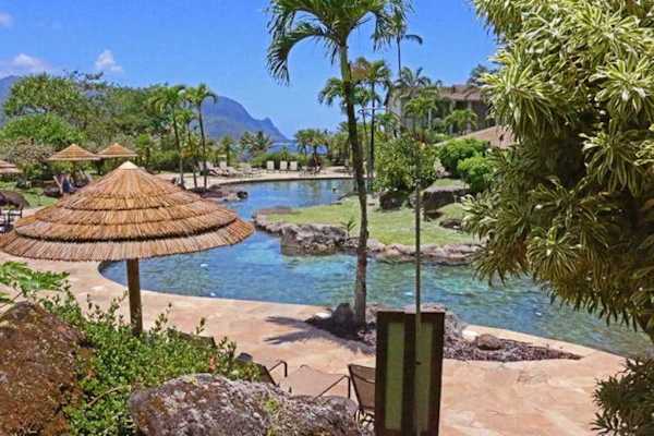 Relax beside the peaceful pool surrounded by lush tropical landscaping