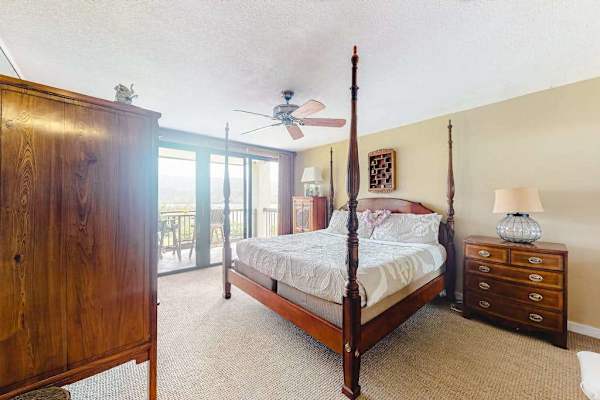 Recharge comfortably in this peaceful bedroom with relaxing outdoor views