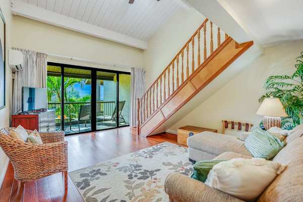 Relax together in this airy living room beneath vaulted ceilings