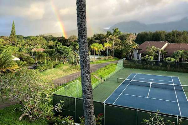 Stay active on tennis courts surrounded by lush tropical scenery