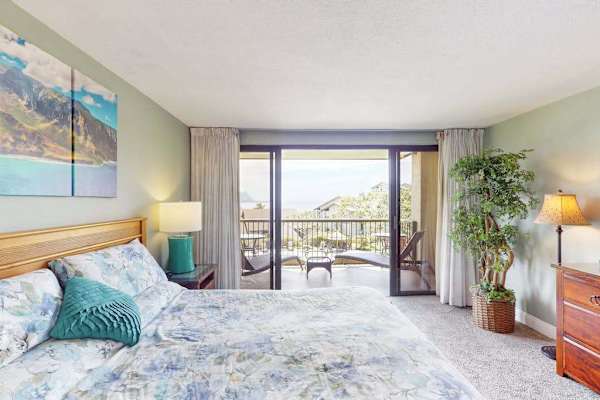Relax in this bright bedroom overlooking beautiful tropical island scenery
