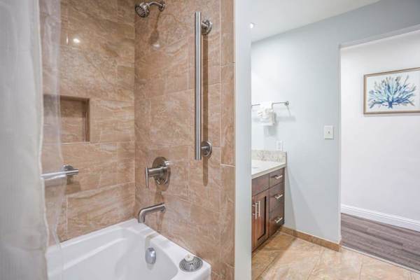 Spacious walk-in shower with bath tub offers a refreshing start to each morning