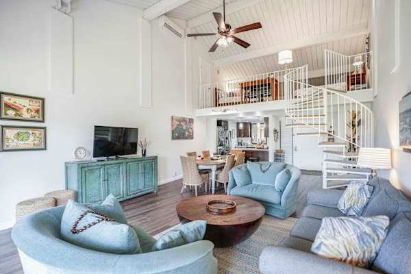 Spacious living area offers comfortable seating beneath soaring vaulted ceilings