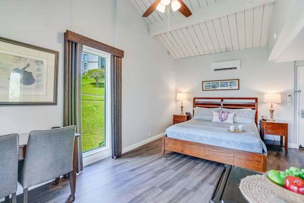 Relax in this airy bedroom with easy outdoor access nearby