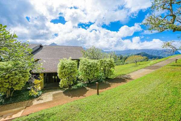 Peaceful property surroundings showcase vibrant greenery and distant mountain views