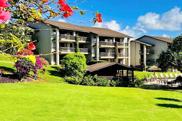 Charming property exterior surrounded by beautiful tropical greenery and sunshine