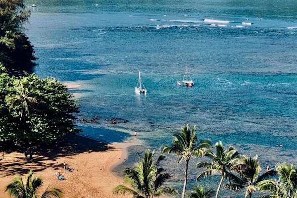 Admire sparkling blue waters surrounded by beautiful tropical island scenery