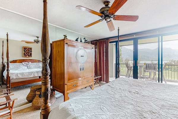  Large, freestanding wooden armoire placed along the mirrored wall