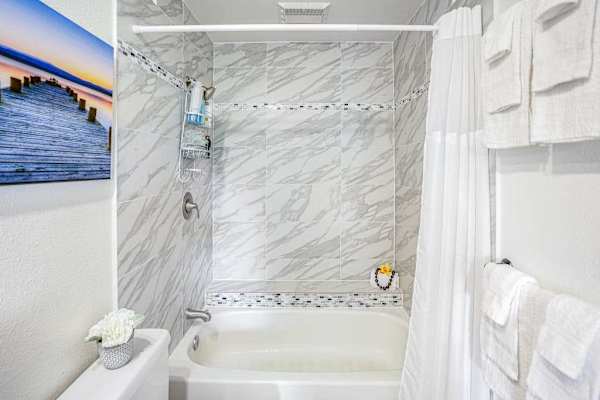 Refresh In A Bright Marble-Finished Bathroom