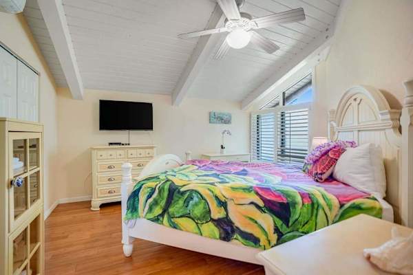 Guest bedroom with queen bedroom with flat screen tv.