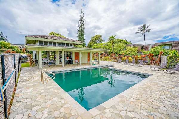 Sparkling Resort Swimming Pool surrounded by Tropical Landscaping 