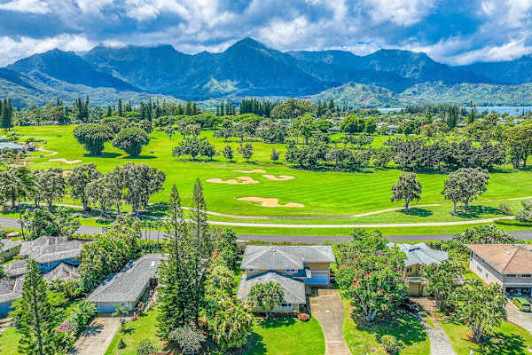 Striking residential golf course neighborhood with distant mountain ranges