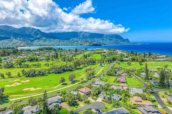 Homes surrounded by lush green golf courses and views of the coastline.