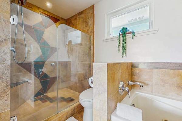 Compact modern bathroom layout featuring a walk-in glass shower